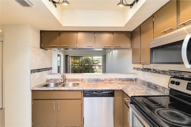 kitchen featuring stainless steel appliances, sink, and decorative backsplash