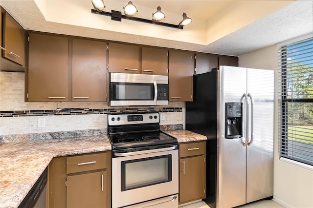 kitchen with tasteful backsplash and appliances with stainless steel finishes