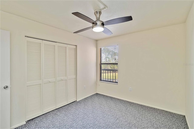 unfurnished bedroom featuring carpet floors, a closet, and ceiling fan