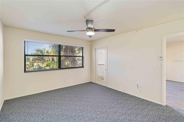 carpeted empty room featuring ceiling fan