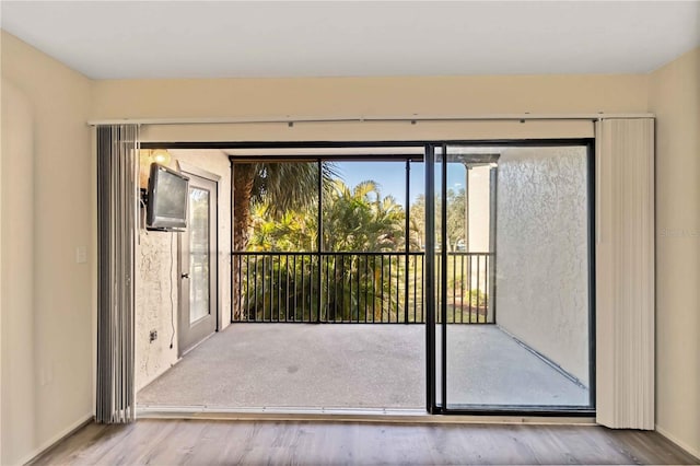 doorway with wood-type flooring