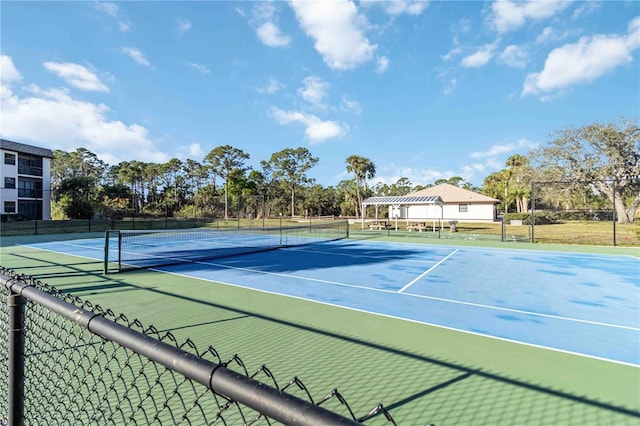 view of tennis court with a pergola