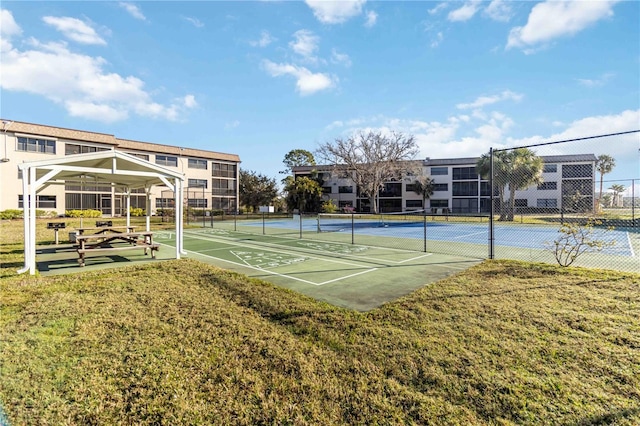 view of sport court with a yard