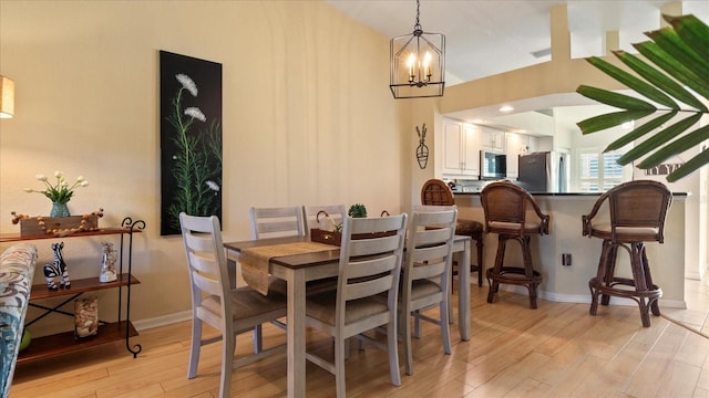 dining room featuring a chandelier and light hardwood / wood-style floors