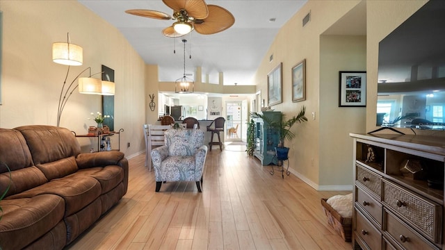 living room featuring ceiling fan and light hardwood / wood-style floors