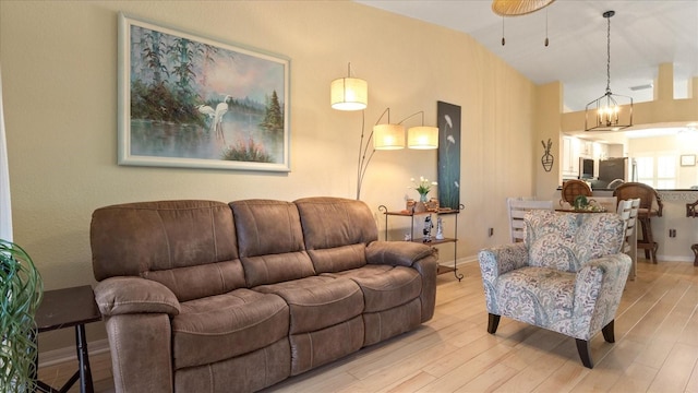 living room with lofted ceiling and light wood-type flooring