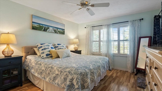 bedroom with ceiling fan and dark hardwood / wood-style flooring