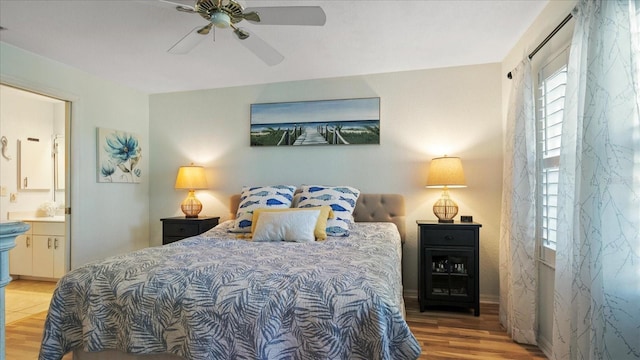 bedroom with connected bathroom, wood-type flooring, and ceiling fan