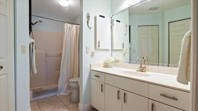 bathroom with tile patterned flooring, vanity, curtained shower, and toilet