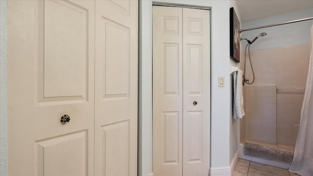 bathroom featuring tile patterned flooring and a shower with shower curtain