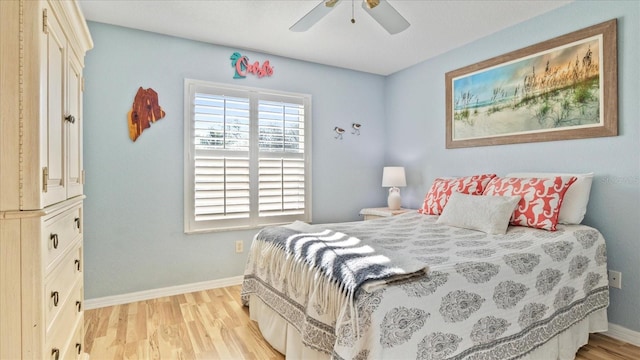 bedroom with ceiling fan and light hardwood / wood-style flooring