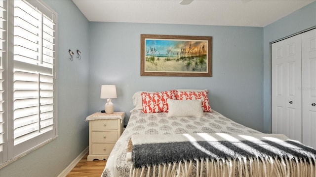 bedroom featuring a closet and light wood-type flooring