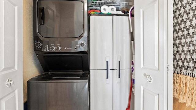 clothes washing area with stacked washer / drying machine