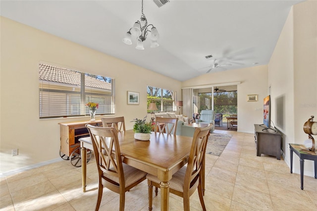 tiled dining space with ceiling fan with notable chandelier and vaulted ceiling