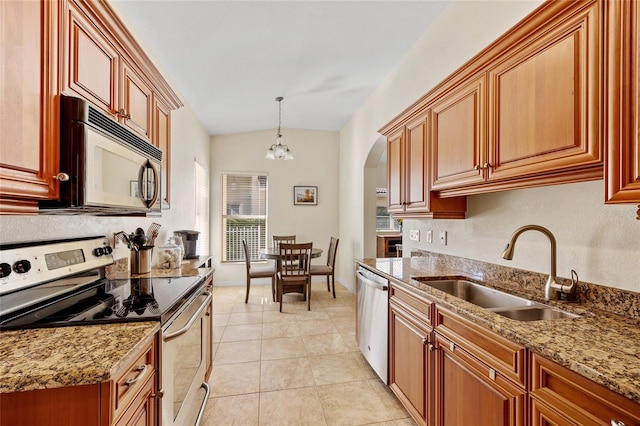 kitchen with sink, light stone counters, decorative light fixtures, light tile patterned floors, and appliances with stainless steel finishes