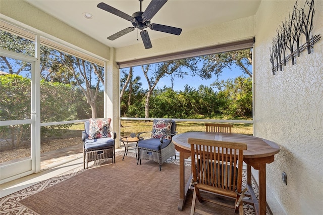 sunroom featuring ceiling fan