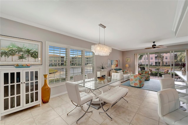 tiled dining room with crown molding and ceiling fan with notable chandelier