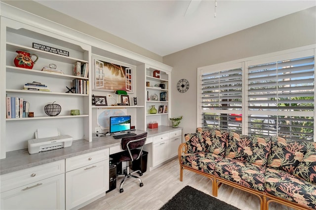 office space featuring built in desk and light hardwood / wood-style floors