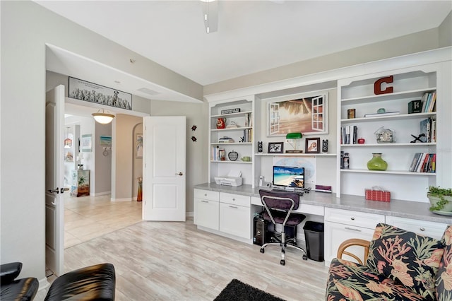 office area featuring built in desk and light hardwood / wood-style floors