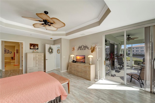 bedroom featuring access to outside, ceiling fan, a tray ceiling, crown molding, and light wood-type flooring