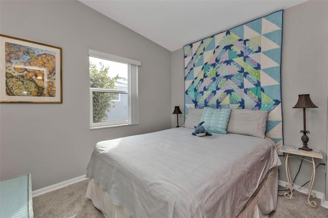 carpeted bedroom with vaulted ceiling