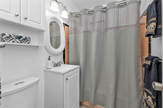 bathroom featuring vanity, toilet, and a shower with shower curtain