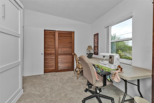 carpeted office featuring lofted ceiling