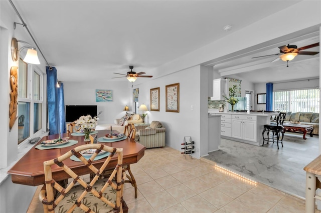 tiled dining space featuring ceiling fan