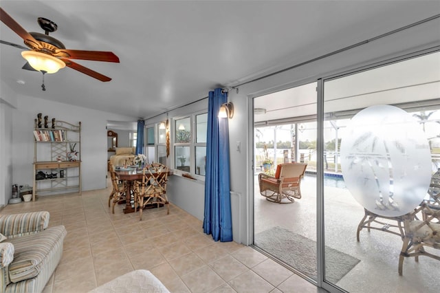 tiled living room with ceiling fan and lofted ceiling