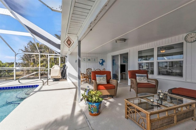 view of patio with outdoor lounge area and glass enclosure