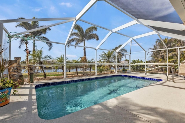 view of swimming pool featuring a patio area, a water view, and glass enclosure