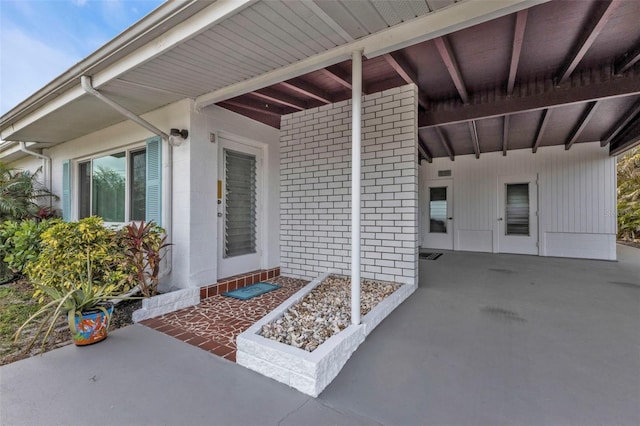 property entrance featuring a patio area