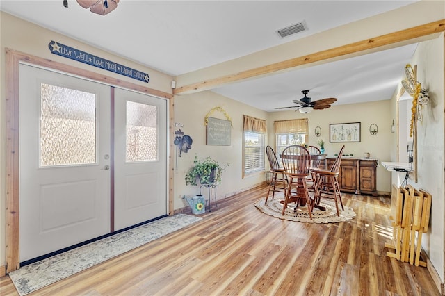 foyer entrance with beamed ceiling, ceiling fan, and hardwood / wood-style floors