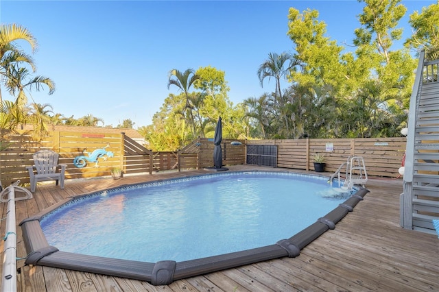 view of swimming pool with a wooden deck