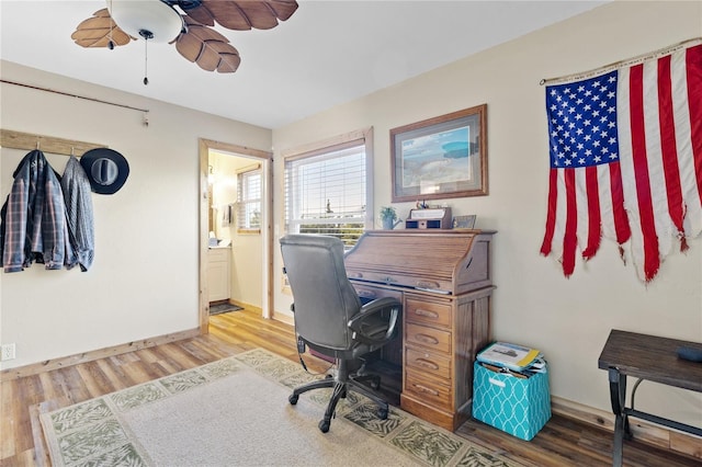 office with hardwood / wood-style flooring and ceiling fan