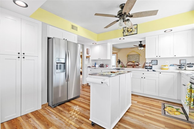 kitchen featuring white cabinets, stainless steel fridge, ceiling fan, kitchen peninsula, and light wood-type flooring