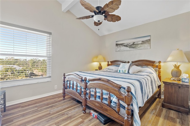 bedroom with wood-type flooring, lofted ceiling with beams, and ceiling fan