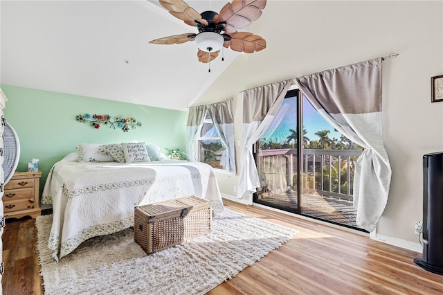 bedroom with hardwood / wood-style floors, lofted ceiling, access to outside, and ceiling fan