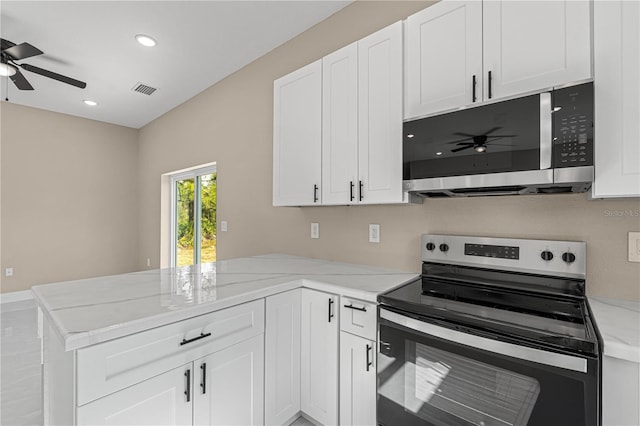 kitchen featuring white cabinetry, appliances with stainless steel finishes, kitchen peninsula, and light stone counters