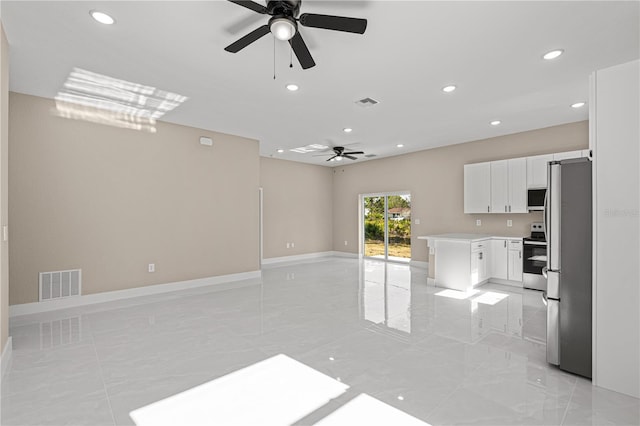 kitchen featuring appliances with stainless steel finishes, white cabinets, and ceiling fan