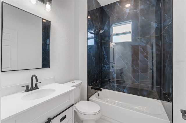 full bathroom with vanity, tiled shower / bath combo, and toilet