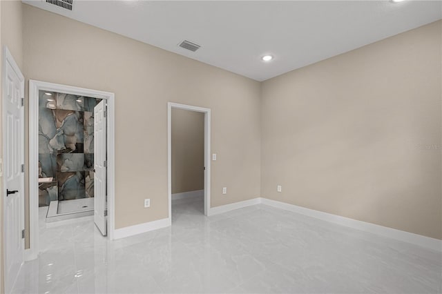 unfurnished bedroom with marble finish floor, recessed lighting, visible vents, a spacious closet, and baseboards