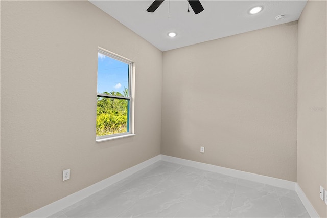 unfurnished room with recessed lighting, marble finish floor, and baseboards