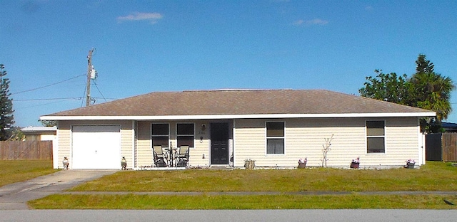 ranch-style home with a garage and a front yard