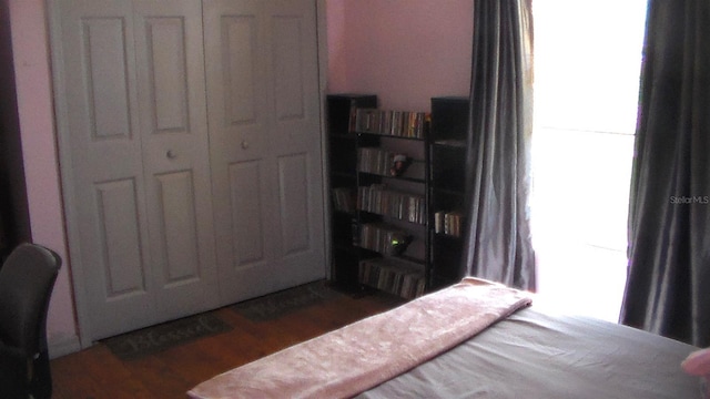 bedroom with dark hardwood / wood-style flooring