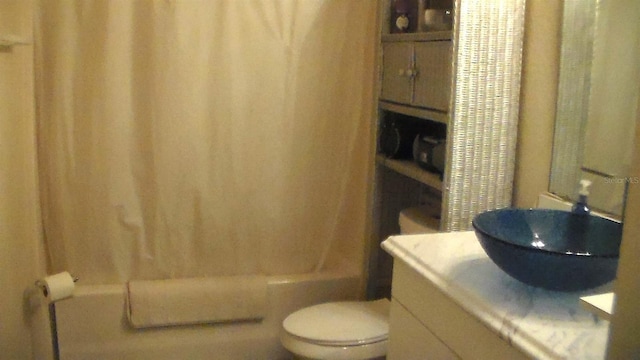 full bathroom featuring vanity, toilet, and shower / tub combo