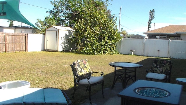 view of yard with a shed and a fire pit