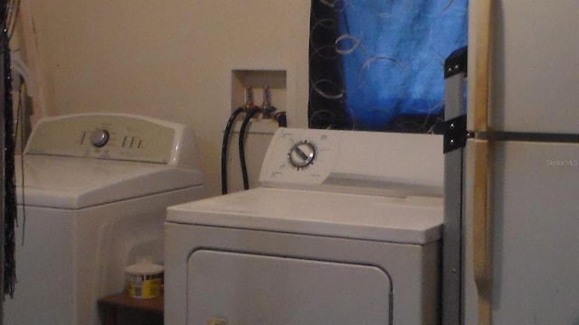 clothes washing area with washer and dryer