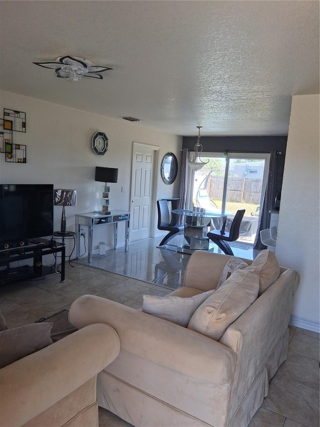 3380 Maple Ter, Port Charlotte, FL 33952 - living area featuring baseboards, visible vents, tile patterned floors, and a textured ceiling