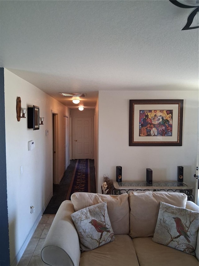 3380 Maple Ter, Port Charlotte, FL 33952 - living room featuring tile patterned floors, a textured ceiling, baseboards, and visible vents